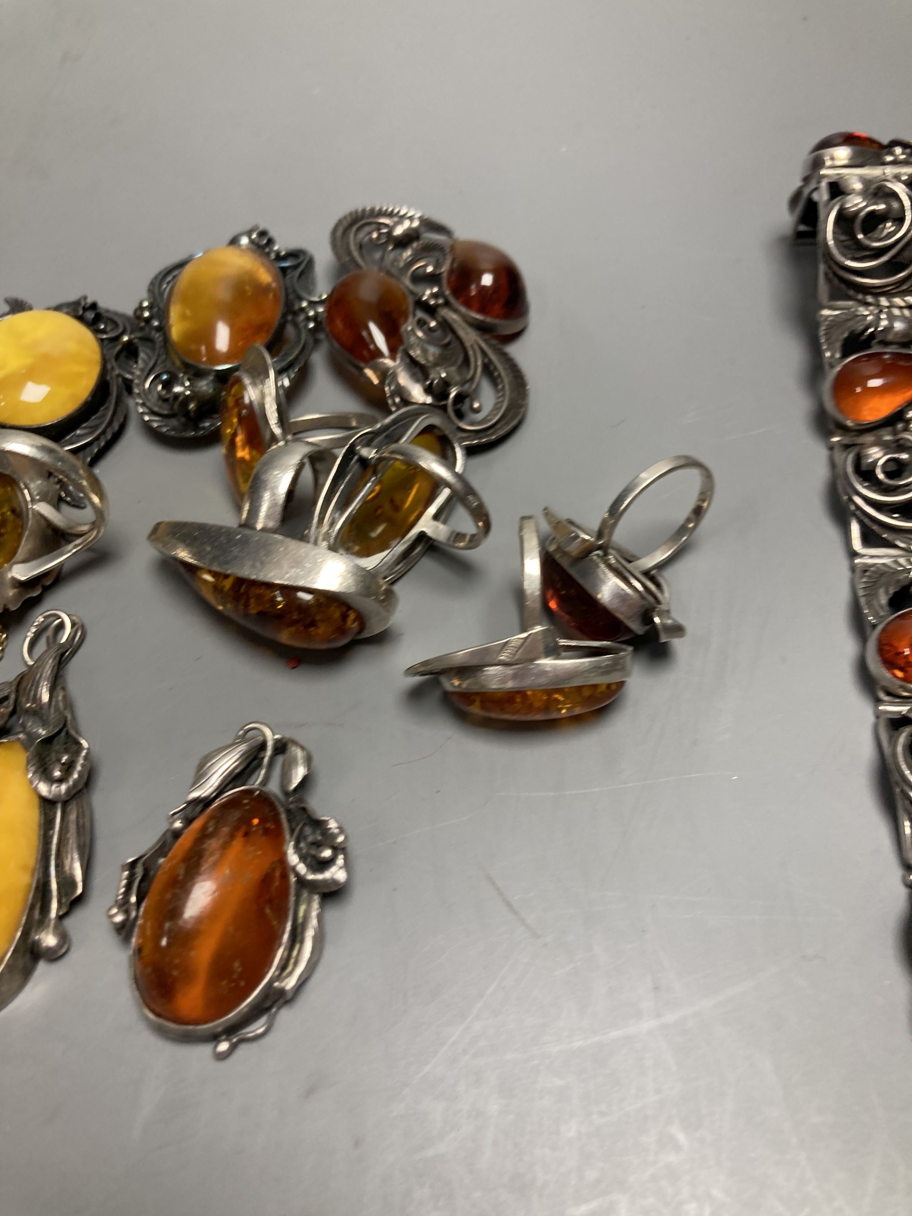 A mixed group of amber jewellery including white metal mounted bangle and Portuguese 925 bracelet.